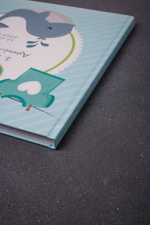 Izmail, Ukraine. June 2020. Baby photo album or photobook with blue whale on grey background. Inscription: Artem 1 year, 12 June, some dataのeditorial素材