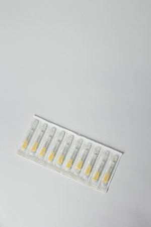 Syringe needles set in plastic package on white background. Medical equipment for injections, vaccination or cosmetology. Copy space.の写真素材