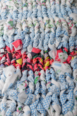 Braid knit pattern background, closeup. Knitting yarn made from multicolored cut textile. Knitted...