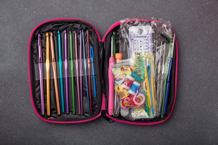 Crochet tools kit, set of crocheting hooks in a case. Organizer with thimble, pins, markers and other equipment for creative handicraft.の写真素材