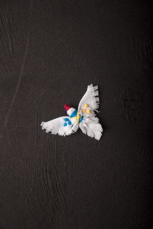 White dove, symbol of peace with Ukrainian national flag colored embroidery stitches. Textile brooch...