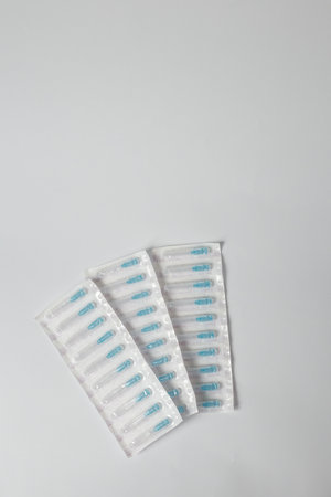 Syringe needles set in plastic package on white background. Medical equipment for injections, vaccination or cosmetology. Copy space.の写真素材