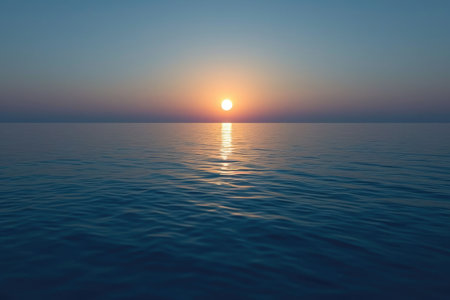 Beautiful sunset over the ocean. The orange disk of the sun sets behind the horizon in an atmosphere of peace and quietの素材