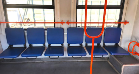Empty carriage with blue seats of a city or intercity electric train. City transport, carriage interiorの写真素材