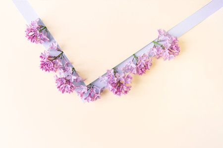 Beautiful flower arrangement. Lilac flowers, free space for text on a light pastel background....