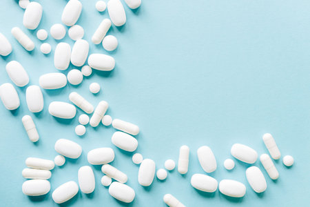 White pills on a pastel background. Capsules and round pills close-up. health care and medicine.