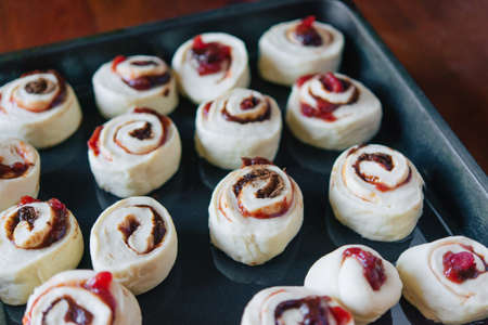Making yeast buns with jam and chocolate. Handmade homemade cakes.の写真素材