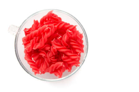 Close-up background of Fusille and Rotini in a glass bowl on white. pastaの写真素材