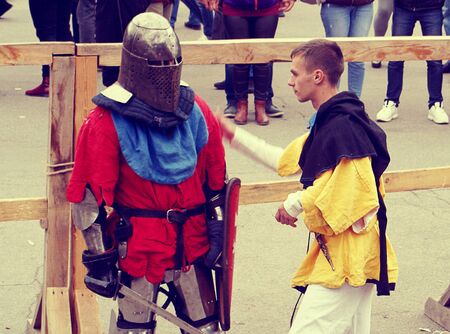 Knight Tournament in Dnipro city on 14.10.19, Ukraine. Historical fencing competition contest. assistant helps the contestant  before the fightのeditorial素材