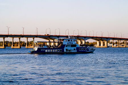 A boat AURA sailing not far from bridge in Dnipro river in the Dnipro city, Ukraine. The photo taken on 13.10.19のeditorial素材