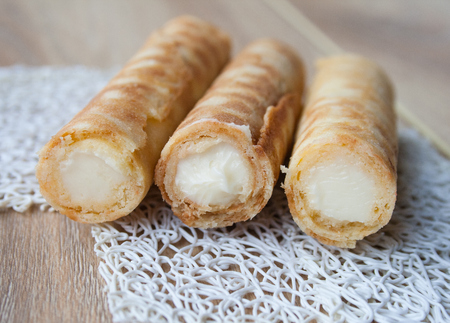 Three sweet rolls with butter cream on a white backgroundの写真素材