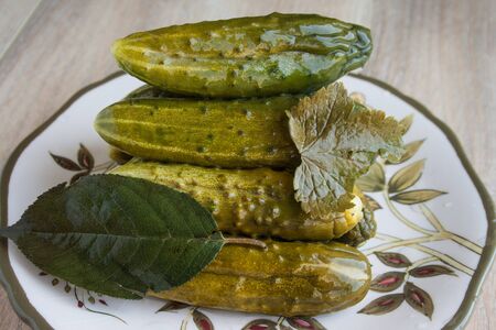 Mouth-watering pickles on a plate with an ornamentの写真素材