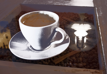 Cup of coffee on a glass background stylized as old photos, sepia filterの写真素材