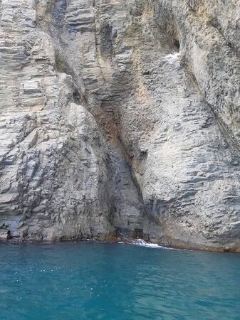 Sea grotto. Grotto in a sheer cliff in the sea. Photo of a sea grotto. Photoの写真素材