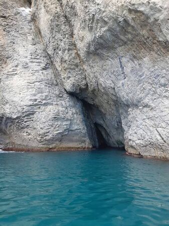Sea grotto. Grotto in a sheer cliff in the sea. Photo of a sea grotto. Photoの写真素材