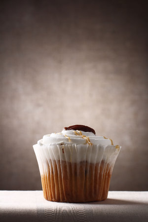 marple and pecan sponge cup cake on brown rustic background, Low Key  Lighting Techniqueの写真素材