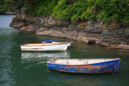 old cog fishing boats on the sea, white blue and orange, Cornwell, Englandの写真素材