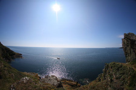 sea view from cliffs, blue sky and sun, Cornwall, England