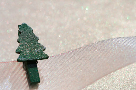 Christmas tree peg on ribbon with glitter sparkles dust background , super macro, shallow DOF