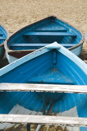 old used wooden row boat on a sandy beach sandの写真素材