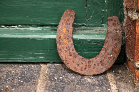 old horseshoe near green barn door, very ruralの写真素材