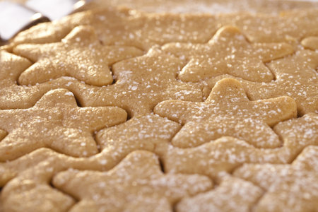 gingerbread  star cookie cuts dough, shallow dof