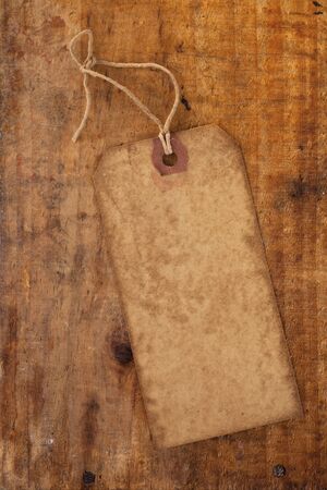 old paper tag with string on grunge wooden tableの写真素材