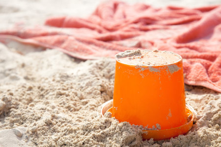 beach bucket tiy and towel on beach sand, shallow dofの写真素材