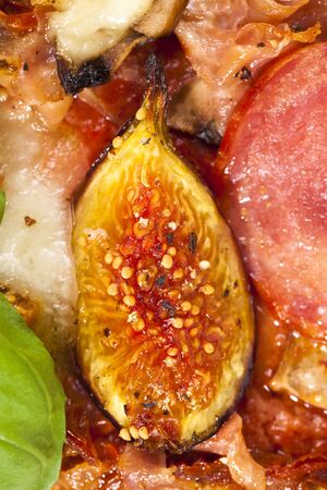 delicious fig, mozzarella and ham pizza, closeup detailsの写真素材
