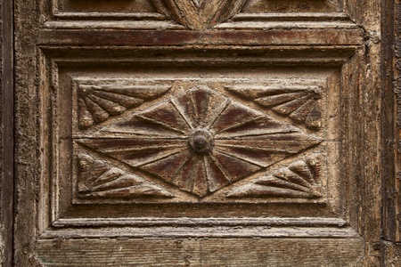 old ornamental design in wood, wooden carved door detailの写真素材