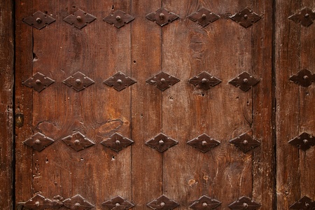 old wooden door with metal ornate backgroundの写真素材