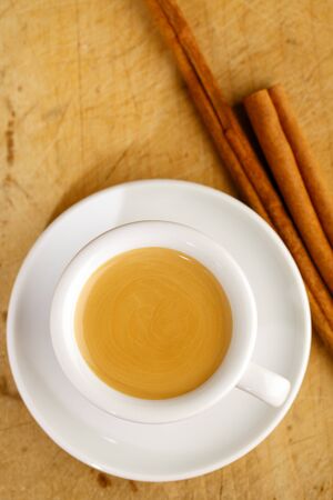 espresso coffee in thick white cup with Cinnamon sticks , on woodの写真素材
