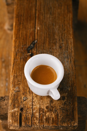 espresso coffee in thick white cup on old wooden benchの写真素材