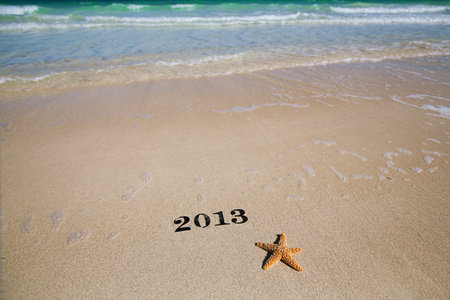 2013 new year metal numbers on beach sea sand, shallow DOF