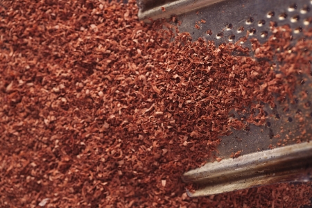 fine grated chocolate on grater , shallow dofの写真素材