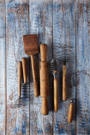 retro kitchen utensils tools on old wooden table in rustic styleの写真素材