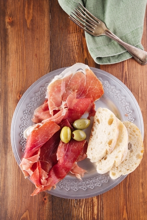 Platter of serrano jamon Cured Meat, Ciabatta, chorizo and olivesの写真素材