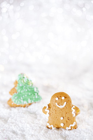 Gingerbread man and tree on a festive Christmas snow background, nice postcard