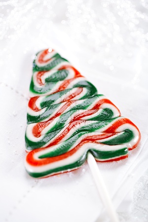 christmas tree lolly on a festive Christmas snow backgroundの写真素材