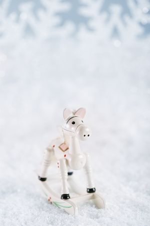 horse christmas decoration on white snow backgroundの写真素材