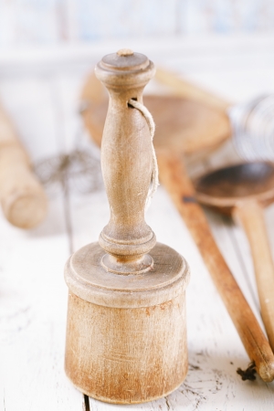 retro kitchen utensils  masher on old wooden table in rustic styleの写真素材