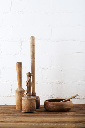 mashers retro kitchen utensils  on old wooden table in rustic styleの写真素材