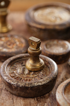 Vintage  iron and brass kitchen  weights on old wooden tableの写真素材