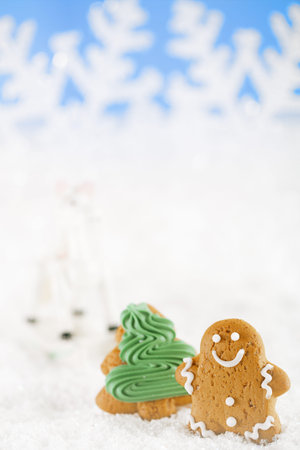 Gingerbread man and christmas tree  on a festive Christmas snow background, nice postcard