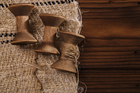 real old reels spools with hemp treads on old grain sacking linen Completely hand made  handwoven and homespunの写真素材