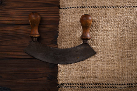real vintage iron and wood herb chopper  on old grain sacking linen Completely hand made  handwoven and homespunの写真素材