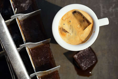 espresso with ice cubes coffee and vintage ice cube trayの写真素材