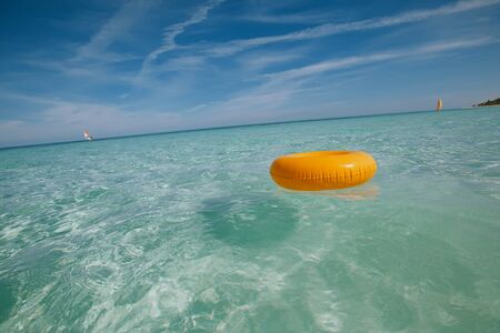 floating ring on blue clear sea with seascape, shallow dofの写真素材