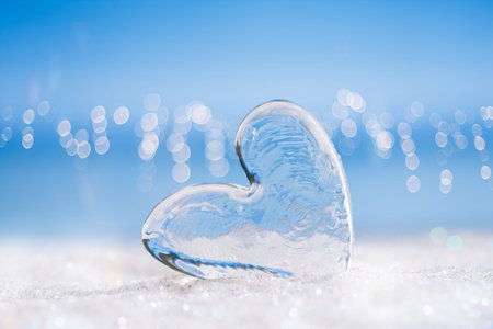 clear glass heart on white  glitter and blue abstract backgroundの写真素材