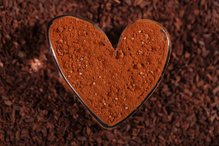 cocoa sugared  powder  dusted heart shaped glass with grated chocolate, perfect color and background
